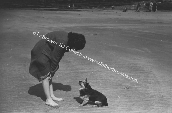 WOMAN WITH DOG ON BEACH